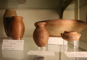 ancient clay pottery displayed in a museum case